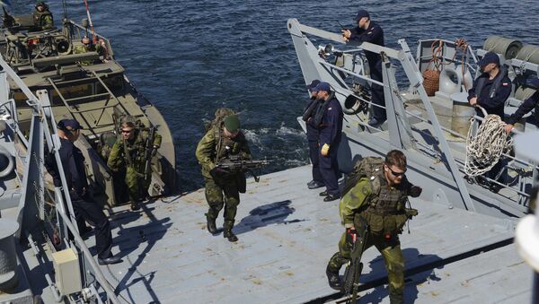 Swedish soldiers arrive aboard the Polish navy ship during the Baltops drills . file photo - Sputnik International