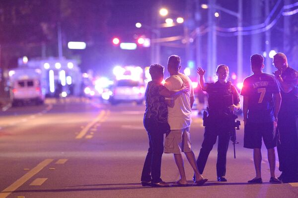 Orlando Police officers direct family members away from a multiple shooting at a nightclub in Orlando, Fla., Sunday, June 12, 2016 - Sputnik International