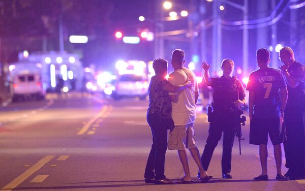 Orlando Police officers direct family members away from a multiple shooting at a nightclub in Orlando, Fla., Sunday, June 12, 2016 - Sputnik International