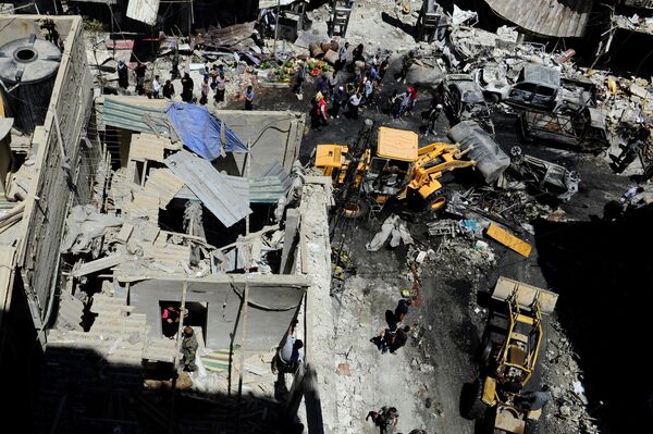 People and Syrian Army members inspect a damaged site after a suicide and car bomb attack in south Damascus Shi'ite suburb of Sayeda Zeinab, Syria June 11, 2016 People and Syrian Army members inspect a damaged site after a suicide and car bomb attack in south Damascus Shi'ite suburb of Sayeda Zeinab, Syria June 11, 2016 - Sputnik International