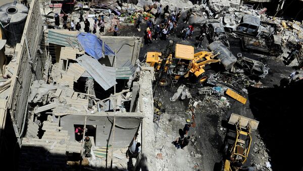 People and Syrian Army members inspect a damaged site after a suicide and car bomb attack in south Damascus Shi'ite suburb of Sayeda Zeinab, Syria June 11, 2016 - Sputnik International