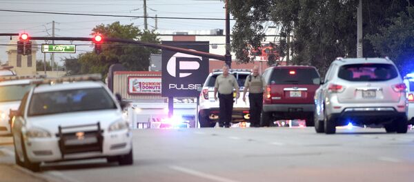 Police cars surround the Pulse Orlando nightclub, the scene of a fatal shooting, in Orlando, Fla., Sunday, June 12, 2016 - Sputnik International