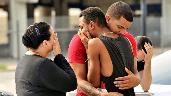 Friends and family members embrace outside the Orlando Police Headquarters during the investigation of a shooting at the Pulse night club, where as many as 20 people have been injured after a gunman opened fire, in Orlando, Florida, U.S June 12, 2016 - Sputnik International