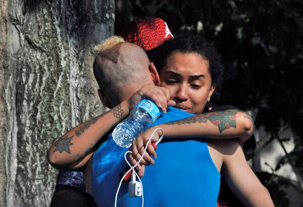Friends and family members embrace outside the Orlando Police Headquarters during the investigation of a shooting at the Pulse nightclub, where people were killed by a gunman, in Orlando, Florida, U.S June 12, 2016 Friends and family members embrace outside the Orlando Police Headquarters during the investigation of a shooting at the Pulse nightclub, where people were killed by a gunman, in Orlando, Florida, U.S June 12, 2016 - Sputnik International