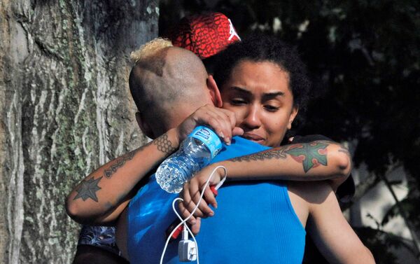 Friends and family members embrace outside the Orlando Police Headquarters during the investigation of a shooting at the Pulse nightclub, where people were killed by a gunman, in Orlando, Florida, U.S June 12, 2016 - Sputnik International