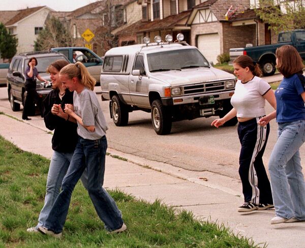 Students from Columbine High School are led away from the facility after two gunmen went on a shooting rampage Tuesday, April 20, 1999, in the southwest Denver suburb of Littleton, Colo. Students from Columbine High School are led away from the facility after two gunmen went on a shooting rampage Tuesday, April 20, 1999, in the southwest Denver suburb of Littleton, Colo. - Sputnik International