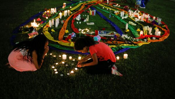 Ten-year-old twins Erica (L) and Olivia Hartley light candles after a vigil in memory of victims one day after a mass shooting at the Pulse gay night club in Orlando, Florida, U.S., June 13, 2016 - Sputnik International