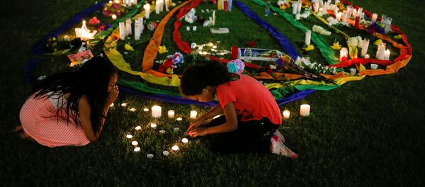 Ten-year-old twins Erica (L) and Olivia Hartley light candles after a vigil in memory of victims one day after a mass shooting at the Pulse gay night club in Orlando, Florida, U.S., June 13, 2016 Ten-year-old twins Erica (L) and Olivia Hartley light candles after a vigil in memory of victims one day after a mass shooting at the Pulse gay night club in Orlando, Florida, U.S., June 13, 2016 - Sputnik International