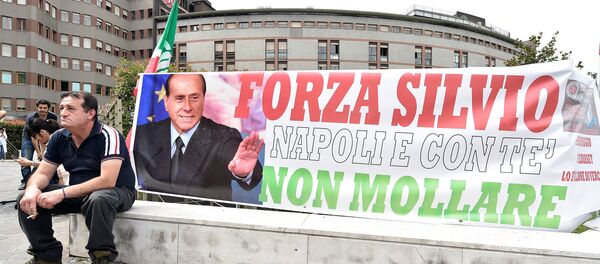 A man sits next to a banner reading Come on Silvio, Naples is with you, never give up in front of San Raffaele hospital, as Italian surgeons begin a four-hour heart operation on former prime minister Silvio Berlusconi on Tuesday to replace a defective aortic valve, a hospital statement said, in Milan, Italy June 14, 2016. - Sputnik International