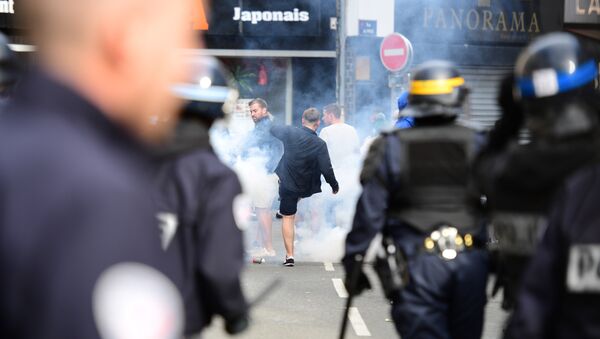 French policemen fire tear gas to disperse supporters gathering outside a bar in Lille, northern France - Sputnik International