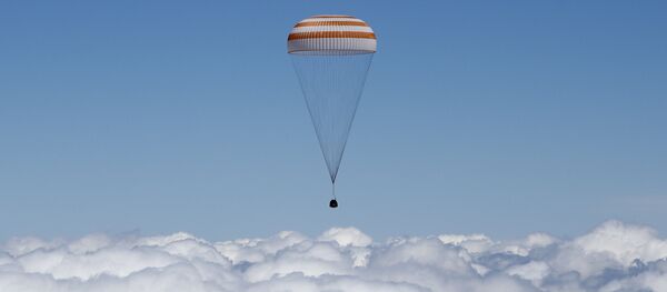 The Soyuz TMA-19M capsule carrying International Space Station (ISS) crew members, Tim Peake of Britain, Yuri Malenchenko of Russia and Tim Kopra of the U.S., descends beneath a parachute just before landing near the town of Zhezkazgan, Kazakhstan, on June 18, 2016 The Soyuz TMA-19M capsule carrying International Space Station (ISS) crew members, Tim Peake of Britain, Yuri Malenchenko of Russia and Tim Kopra of the U.S., descends beneath a parachute just before landing near the town of Zhezkazgan, Kazakhstan, on June 18, 2016 - Sputnik International