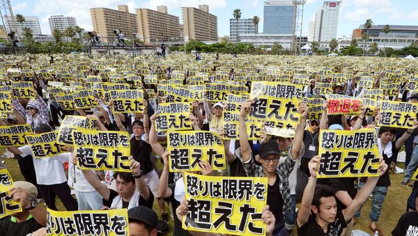 Protesters raise placards reading Anger was over the limit during a rally against the U.S. military presence on the island and a series of crimes and other incidents involving U.S. soldiers and base workers, at a park in the prefectural capital Naha on Japan's southern island of Okinawa, Japan, in this photo taken by Kyodo June 19, 2016 - Sputnik International