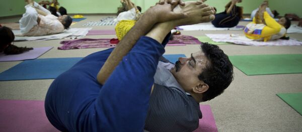 In this Thursday, June 18, 2015, photo, Indian perform Yoga at the Morarji Desai National instate of yoga, in New Delhi, India - Sputnik International
