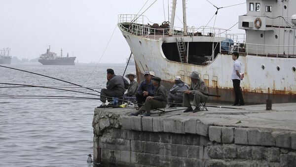 North Korean men fish off a pier on Tuesday, June 21, 2016, in Wonsan, North Korea. - Sputnik International