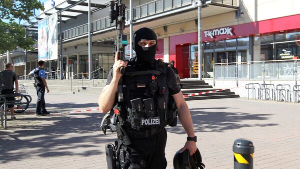 A policeman stands near a cinema where an armed man barricaded himself in Viernheim, southern Germany - Sputnik International