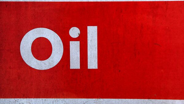 The word oil is pictured on an oil bank at a recycling yard in London - Sputnik International