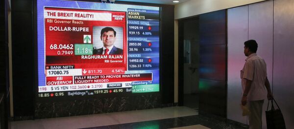 A man watches Reserve Bank of India governor Raghuram Rajan commenting on the situation after stock markets tumbled worldwide, on a stock markets indicator board in Mumbai, India, Friday, June 24, 2016. A man watches Reserve Bank of India governor Raghuram Rajan commenting on the situation after stock markets tumbled worldwide, on a stock markets indicator board in Mumbai, India, Friday, June 24, 2016. - Sputnik International