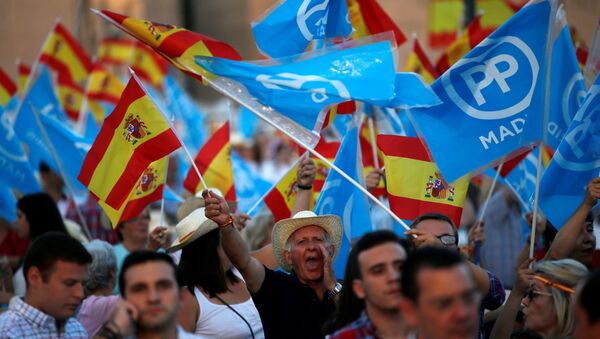 Popular Party supporters hold Spanish flags as they wait for the arrival of Spain's acting Prime Minister and People's Party (PP) leader Mariano Rajoy before the final campaign rally for Spain's general election in Madrid, Spain, June 24, 2016 - Sputnik International