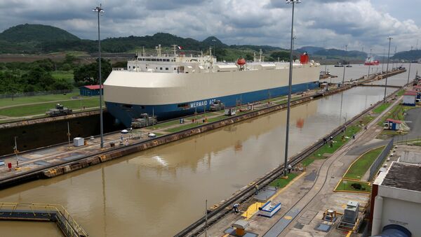 A cargo ship is pictured crossing through the Miraflores locks, a day before the inauguration of the Panama Canal Expansion project, in Panama City, Panama June 25, 2016 - Sputnik International