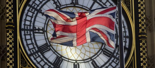 The Union flag is seen flapping in the wind in front of one of the faces of the Great Clock atop the landmark Elizabeth Tower that houses Big Ben at the Houses of Parliament where lawmakers are expected to vote in favour of joining air strikes against Islamic State (IS) militants in central London on 26 September, 2014 - Sputnik International