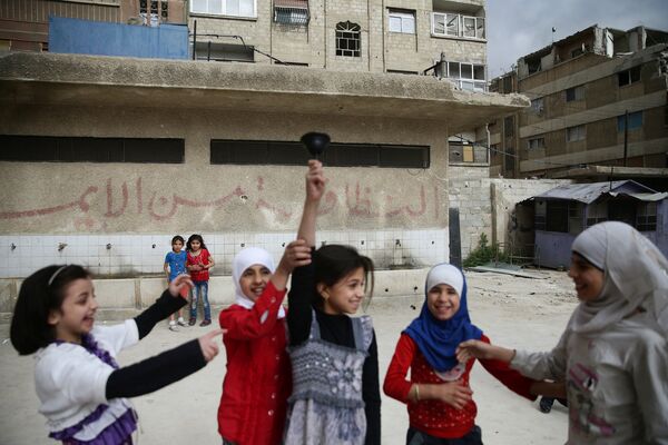 Girls ring a bell inside a school yard in the town of Douma, eastern Ghouta in Damascus, Syria May 24, 2016 Girls ring a bell inside a school yard in the town of Douma, eastern Ghouta in Damascus, Syria May 24, 2016 - Sputnik International