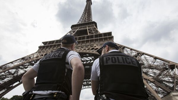 French riot police officers patrol under the Eiffel Tower, near the entrance of the soccer fan zone, prior to the Euro 2016 Group A soccer match between France and Romania, in Paris, Friday, June 10, 2016 - Sputnik International