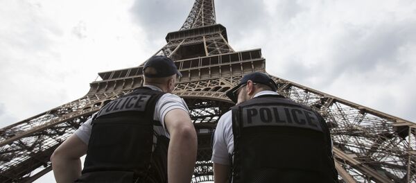 French riot police officers patrol under the Eiffel Tower, near the entrance of the soccer fan zone, prior to the Euro 2016 Group A soccer match between France and Romania, in Paris, Friday, June 10, 2016 French riot police officers patrol under the Eiffel Tower, near the entrance of the soccer fan zone, prior to the Euro 2016 Group A soccer match between France and Romania, in Paris, Friday, June 10, 2016 - Sputnik International