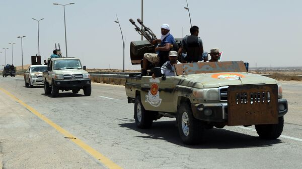 Forces loyal to Libya's UN-backed unity government patrol the entrance of Sirte as they advance to recapture the city from the Islamic State (IS) group jihadists on June 10, 2016 - Sputnik International