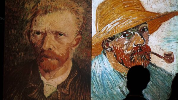 A visitor stands in front of giant screens featuring images of the work of Dutch painter Vincent van Gogh during a traveling multimedia art exhibition entitled Van Gogh alive on February 4, 2013 - Sputnik International