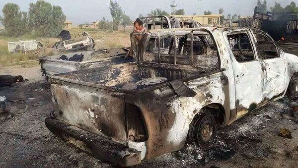 This image released by Iraq's Counterterrorism Service shows a destroyed militant vehicle after Coalition and Iraqi security forces targeted Islamic State fighters fleeing the outskirts of Fallujah, Iraq on Wednesday, June 29, 2016. - Sputnik International