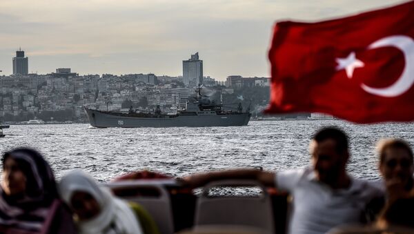A Turkish flag flies on a ferry as Russian warship the BSF Saratov 150 sails through the Bosphorus off Istanbul en route to the eastern Mediterranean sea on September 26, 2015 - Sputnik International