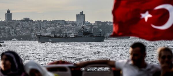 A Turkish flag flies on a ferry as Russian warship the BSF Saratov 150 sails through the Bosphorus off Istanbul en route to the eastern Mediterranean sea on September 26, 2015 A Turkish flag flies on a ferry as Russian warship the BSF Saratov 150 sails through the Bosphorus off Istanbul en route to the eastern Mediterranean sea on September 26, 2015 - Sputnik International