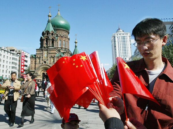 A man shops for flags in front of St. Sophie's Russian Orthodox Cathedral in Harbin, in northeast China's Heilongjiang province A man shops for flags in front of St. Sophie's Russian Orthodox Cathedral in Harbin, in northeast China's Heilongjiang province - Sputnik International