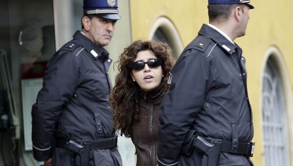 Public relations expert Francesca Chaouqui walks past two Vatican Gendarmi as she leaves the Vatican during a pause of her trial, Tuesday, March 15, 2016 - Sputnik International