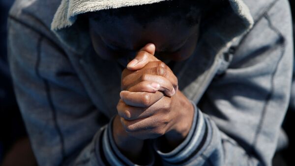 A migrant prays on the Migrant Offshore Aid Station (MOAS) ship Topaz Responder after being rescued around 20 nautical miles off the coast of Libya, June 23, 2016. - Sputnik International