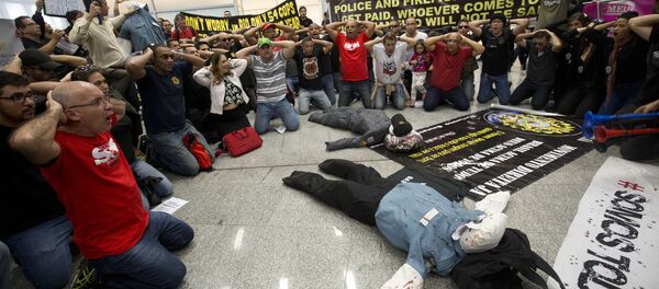 Police officers make a surrender position during a protest, demanding their payments and better labor conditions, at the Tom Jobim International Airport, in Rio de Janeiro, Brazil, Monday, July 4, 2016 - Sputnik International