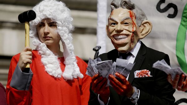 A protester wearing a former British Prime Minister Tony Blair mask, right, and another dressed as a judge pose for the media on a stage outside the Queen Elizabeth II Conference Centre in London, shortly before the publication of the Chilcot report into the Iraq war, Wednesday, July 6, 2016. - Sputnik International