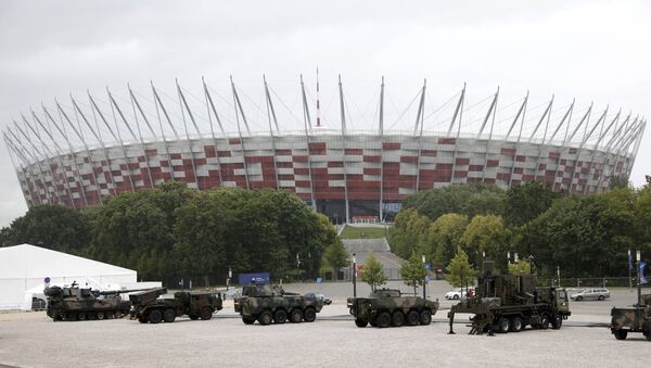 Armoured military vehicles are parked outside PGE National Stadium, the venue of the NATO Summit, in Warsaw, Poland July 8, 2016. - Sputnik International