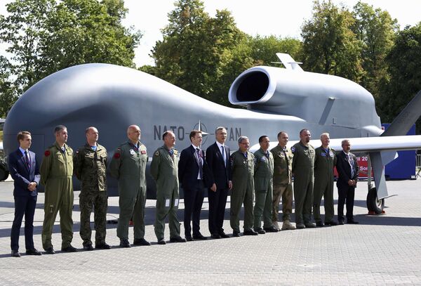 NATO Secretary-General Jens Stoltenberg (C) poses with officials and military personnel in front of a NATO unmanned drone outside PGE National Stadium, the venue of the NATO Summit, in Warsaw, Poland, July 8, 2016. NATO Secretary-General Jens Stoltenberg (C) poses with officials and military personnel in front of a NATO unmanned drone outside PGE National Stadium, the venue of the NATO Summit, in Warsaw, Poland, July 8, 2016. - Sputnik International