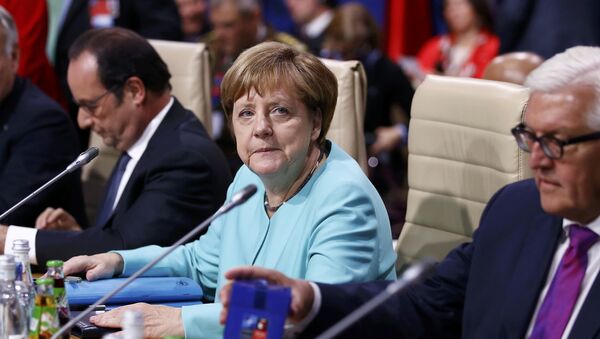 German Chancellor Angela Merkel (C) looks on next to German Foreign Minister Frank-Walter Steinmeier (R) and France's President Francois Hollande during the NATO Summit in Warsaw, Poland July 8, 2016. - Sputnik International