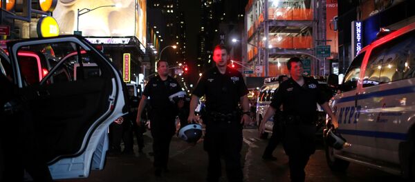 NYPD officers keep an eye on protesters as they go through Times Square taking part in a protest against the killing of Alton Sterling, Philando Castile and in support of Black Lives Matter during a march along Manhattan's streets in New York July 8, 2016. NYPD officers keep an eye on protesters as they go through Times Square taking part in a protest against the killing of Alton Sterling, Philando Castile and in support of Black Lives Matter during a march along Manhattan's streets in New York July 8, 2016. - Sputnik International