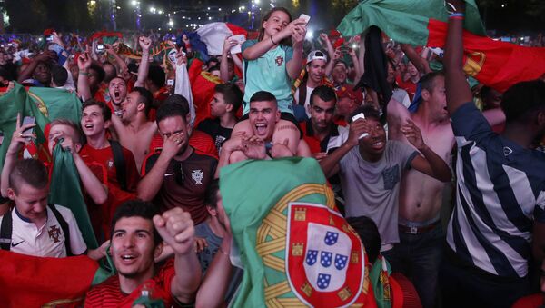 Portugal fans react at the fan zone after their team beat France in the Portugal v France EURO 2016 final soccer match in Paris, France, July 10, 2016 - Sputnik International