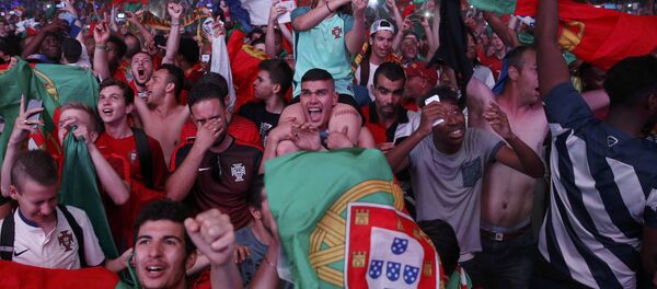 Portugal fans react at the fan zone after their team beat France in the Portugal v France EURO 2016 final soccer match in Paris, France, July 10, 2016 Portugal fans react at the fan zone after their team beat France in the Portugal v France EURO 2016 final soccer match in Paris, France, July 10, 2016 - Sputnik International