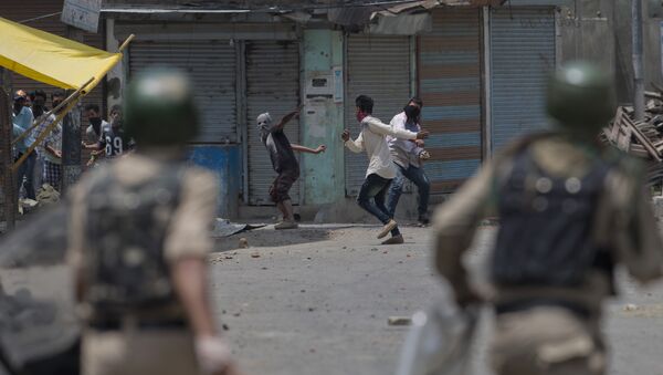 File photo showing Kashmiri Muslim protesters throw bricks and rocks at Indian paramilitary soldiers in Srinagar, Indian controlled Kashmir, Sunday, July 10, 2016 - Sputnik International