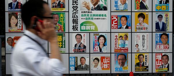 A man walks past Japan's ruling Liberal Democratic Party's (LDP) poster (C) for the July 10 upper house election with the image of Shinzo Abe, Japan's Prime Minister and leader of the LDP, and other candidates' posters at the LDP headquarters in Tokyo, Japan July 10, 2016 A man walks past Japan's ruling Liberal Democratic Party's (LDP) poster (C) for the July 10 upper house election with the image of Shinzo Abe, Japan's Prime Minister and leader of the LDP, and other candidates' posters at the LDP headquarters in Tokyo, Japan July 10, 2016 - Sputnik International
