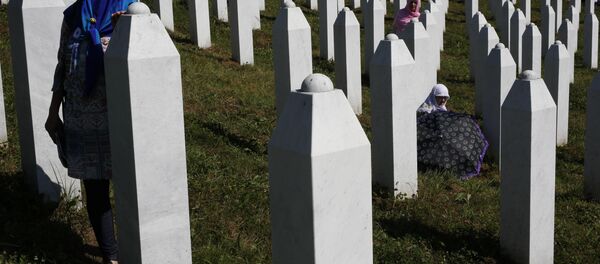 A Bosnian woman prays next to a coffin containing the remains of her relative perished in the Srebrenica massacre, during a funeral ceremony for the 127 victims at the Potocari memorial complex near Srebrenica, 150 kilometers (94 miles) northeast of Sarajevo, Bosnia and Herzegovina, Monday, July 11, 2016 - Sputnik International