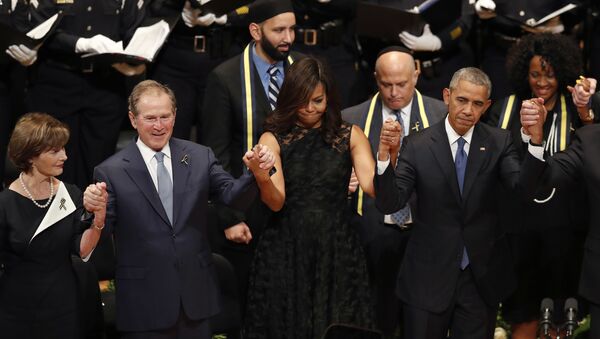 From left, former first lady Laura Bush, former President George W. Bush, first lady Michelle Obama and President Barack Obama join hands during a memorial service at the Morton H. Meyerson Symphony Center with the families of the fallen police officers, Tuesday, July 12, 2016, in Dallas - Sputnik International
