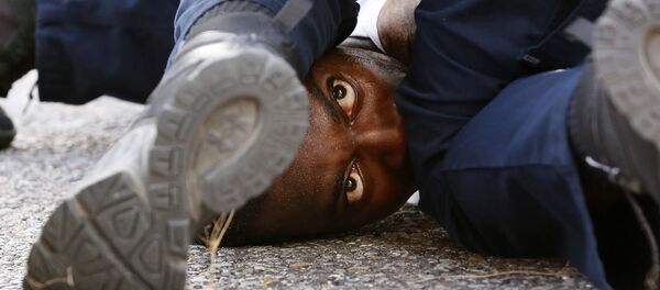 A man protesting the shooting death of Alton Sterling is detained by law enforcement near the headquarters of the Baton Rouge Police Department in Baton Rouge, Louisiana, U.S. July 9, 2016 - Sputnik International