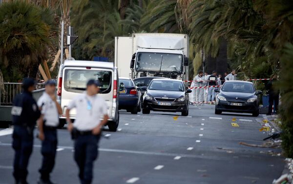 French police continue their investigation as they work near the heavy truck that ran into a crowd at high speed celebrating the Bastille Day July 14 national holiday on the Promenade des Anglais killing 80 people in Nice, France, July 15, 2016. - Sputnik International