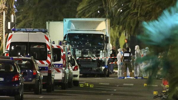 French police forces and forensic officers stand next to a truck July 15, 2016 that ran into a crowd celebrating the Bastille Day national holiday on the Promenade des Anglais in Nice, France, July 14 - Sputnik International
